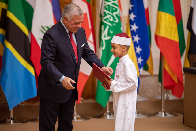 His Majesty King Abdullah honours the winners of the international and local Hashemite Competition for Holy Koran Memorisation and Recitation at the King Hussein bin Talal Mosque on Monday (Photo courtesy of Royal Court)