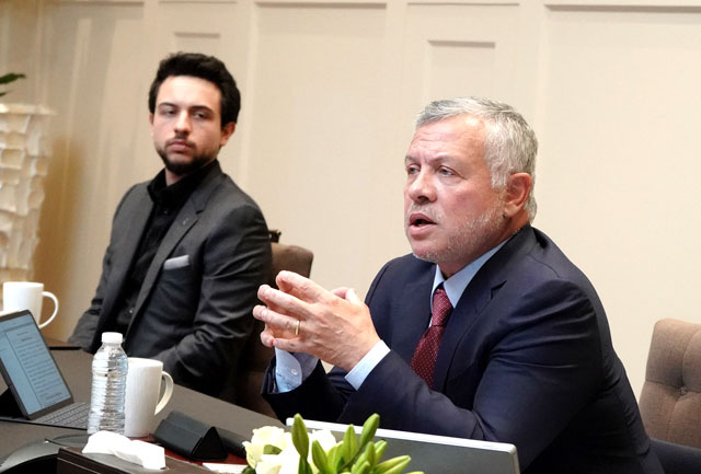 His Majesty King Abdullah, accompanied by HRH Crown Prince Hussein, speaks during a conference call on Tuesday (Photo courtesy of Royal Court)