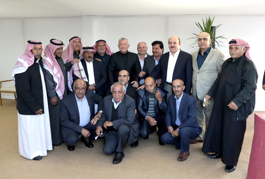 His Majesty King Abdullah poses for a photo with military retirees who served at the Royal Armoured Battalion/2 on Wednesday. The King shared the photo on his twitter handle