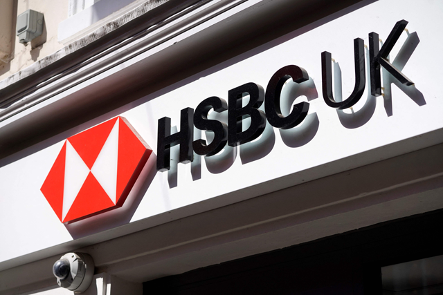 A sign is pictured above a branch of a HSBC bank in central London on April 26, 2022 (AFP photo)