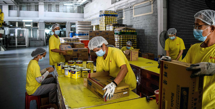 In this photo, taken on August 27, printed labels which read Made in China are used by workers to cover Made in Hong Kong labelling on products at the Koon Chun Sauce Factory in Hong Kong, which produces soy, hoisin and oyster sauces found in Chinese restaurants and kitchens around the world (AFP photo)