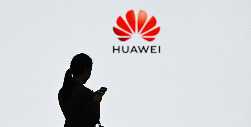 A staff member of Huawei using her mobile phone at the Huawei Digital Transformation Showcase in Shenzhen, China's Guangdong province, on March 6, 2019 (AFP file photo)