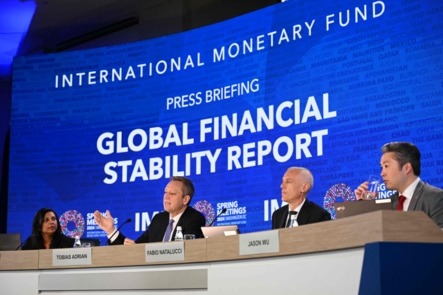 International Monetary Fund (IMF) Communications Officer Meera Louis; Monetary and Capital Markets Director Tobias Adrian; Monetary and Capital Markets Deputy Director Fabio Natalucci; and Assistant Director Jason Wu, hold a press briefing as the IMF publishes its Global Financial Stability Report at the IMF-World Bank Group spring meetings at the IMF headquarters in Washington, DC on Tuesday (AFP photo)