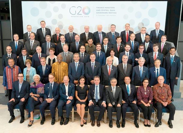 This handout photo taken and released by the IMF on Thursday shows G-20 finance ministers and bank governors posing for a group photograph at the Bali Nusa Dua Convention Centre prior to a dinner at the 2018 IMF/World Bank annual meetings in Nusa Dua  (AFP photo)