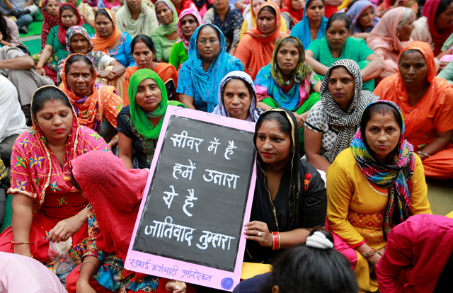 Family members of sanitation workers attend a protest against the rising deaths of people cleaning sewers in New Delhi, India, on Tuesday (Reuters photo)