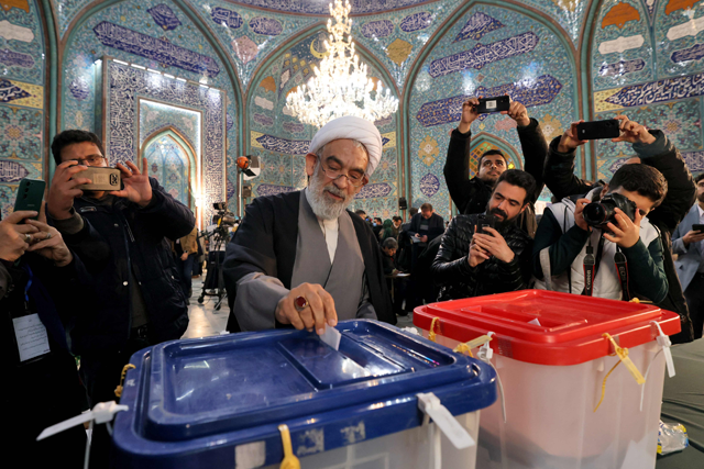 Mohsen Qomi, candidate for the Assembly of Experts casts his ballot at a polling station in Iran's capital Tehran during elections to select members of parliament and a key clerical body on Friday (AFP photo)