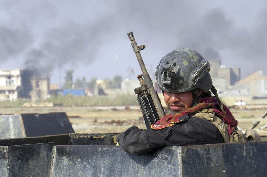 Iraqi forces supported by US-led coalition air strikes advance their position during clashes with the Daesh group in the western suburbs of Ramadi, the capital of Iraq's Anbar province, 115 kilometres west of Baghdad, Iraq, on November 21 (AP photo)