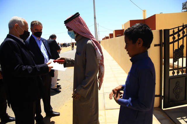 Royal Court Chief Yousef Issawi hands over keys of new houses, built as part of a Royal initiative, to a beneficiary in Maan’s Mudawara district on Saturday  (Petra photo)