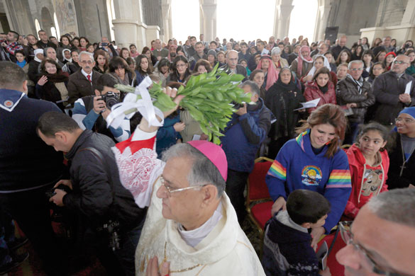 Latin Patriarch of Jerusalem Fouad Twal blesses the faithful during a religious service as part of an annual pilgrimage at John the Baptist Church near the Baptism Site along the Jordan River, on Friday (Reuters photo by Muhammad Hamed)