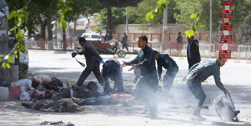 Policemen help Afghan journalists, victims of a second blast, in Kabul, Afghanistan, on Monday (Reuters photo)