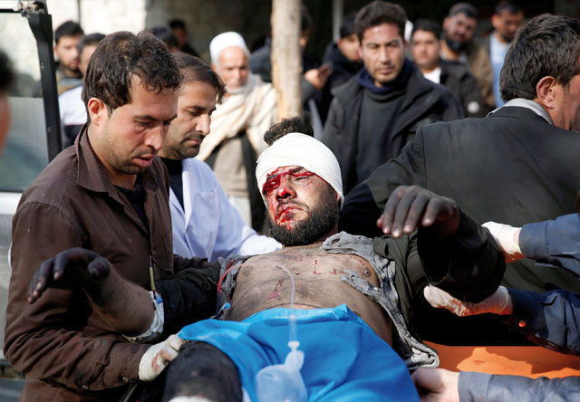 An injured man receives medical assistance after a blast in Kabul, Afghanistan, on Saturday (Reuters photo)