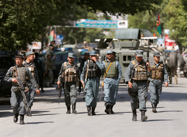 Afghan policemen arrive at the site of an attack and gun fire in Kabul, Afghanistan, on Wednesday (Reuters photo)