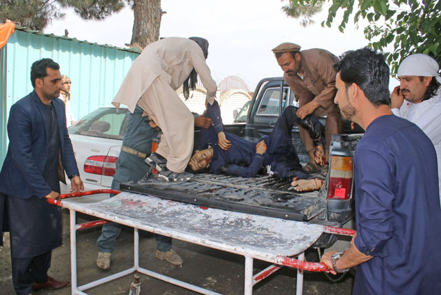 People carry an injured man to a hospital after a blast in Khost province, Afghanistan, on Sunday (Reuters photo)