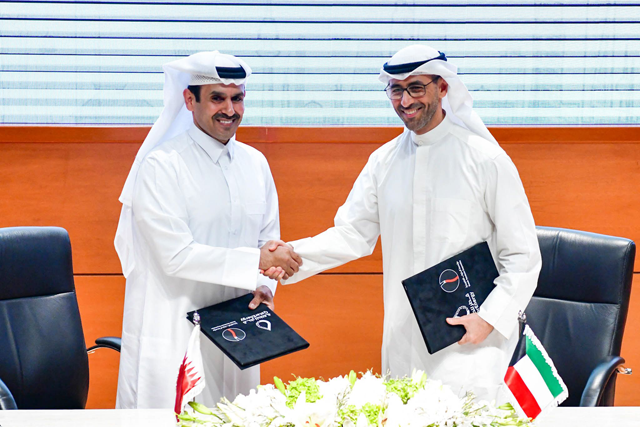 A handout photo released by the Kuwaiti news agency KUNA on Monday shows Deputy Chairman and Chief Executive Officer of the Kuwait Petroleum Corporation (KPC) Sheikh Nawaf Al Sabah (right) and Qatar's Minister of State for Energy Affairs and Managing Director and CEO of QatarEnergy Saad Al Kaabi shaking hands during an agreement signing ceremony at the KPC headquarters in Kuwait City (AFP Photo)