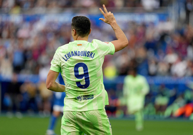 Barcelona's Polish forward #09 Robert Lewandowski celebrates after scoring a hat-trick during the Spanish league football match between Deportivo Alaves and FC Barcelona at the Mendizorroza stadium in Vitoria on Sunday (AFP photo)