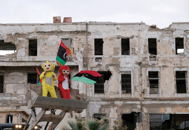 Boys wear costumes and carry Libyan flags during a celebration of the eighth anniversary of the revolution in Benghazi, Libya, on Sunday (Reuters photo)