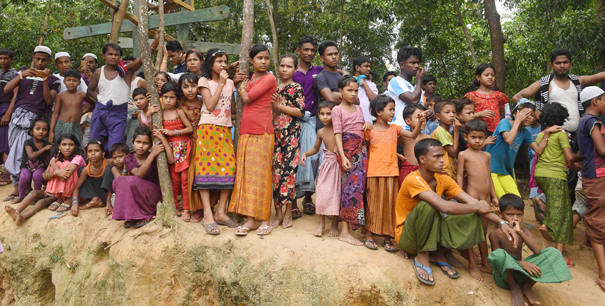 Rohingya refugees look on as others shout slogans as they attend a protest march after attending a ceremony to remember the first anniversary of a military crackdown that prompted a massive exodus of people from Myanmar to Bangladesh, at the Kutupalong refugee camp in Ukhia, on Saturday (AFP photo)