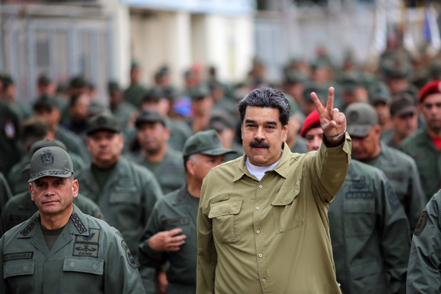 Venezuela’s President Nicolas Maduro (right) flashes the V-sign next to Commandant of the Armed Forces Strategic Command Operations Remigio Ceballos (left) during a military rally, in Caracas, on Wednesday (AFP photo)