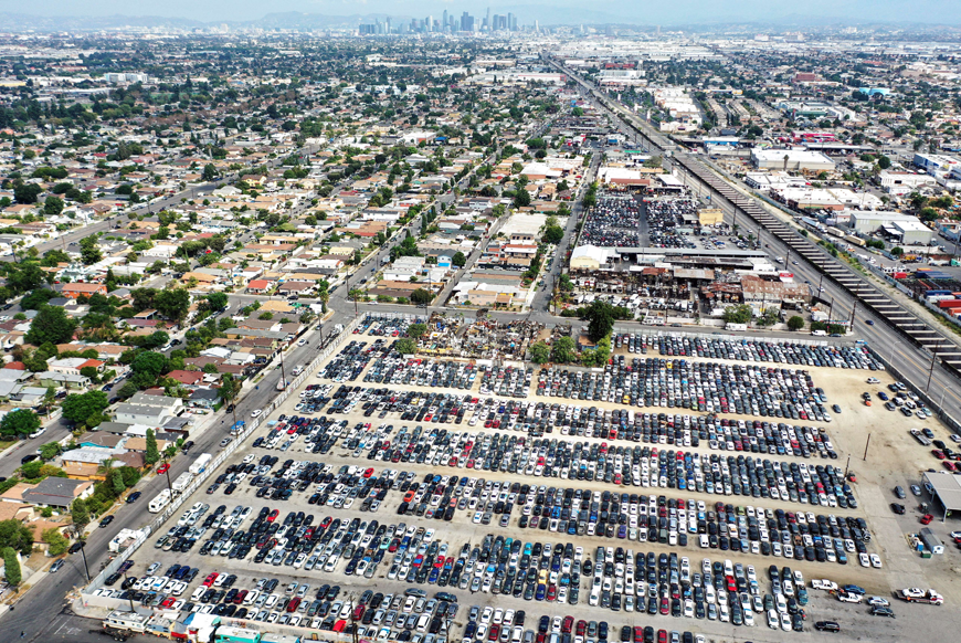 In an aerial view, cars sit on an auto auction lot on Tuesday in Los Angeles, California, while the Bureau of Labour Statistics reported that the Consumer Price Index rose 0.1 per cent from July, after no increase the previous month, as inflationary pressures continue (AFP photo)