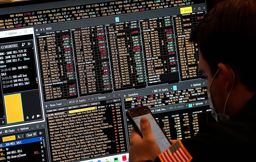 A trader works on the floor of the New York Stock Exchange on Friday, in New York (AFP photo)