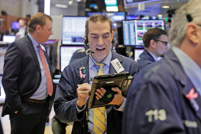 Traders work on the floor of the New York Stock Exchange shortly after the opening bell in New York, US, on Monday (Reuters photo)