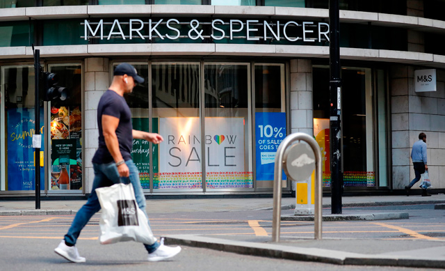 A pedestrian walks past an M&S (Marks and Spencer) store in central London, on Monday (AFP photo)