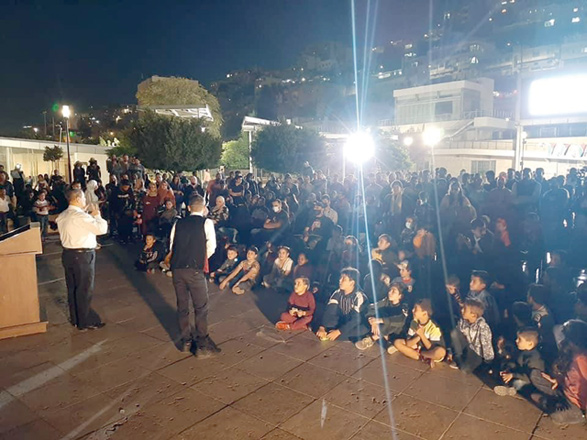 Members of the audience listen to a storytelling session at the Hashemite Plaza in Amman as part of the 14th edition of Hakaya Festival, which kicked off on Friday (Photo courtesy of Hakaya Festival Facebook page)