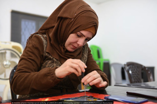 A mobile phone maintenance activity at UNHCR/CARE community centre (Photo courtesy of UNHCR/Mohammad Alyounese)