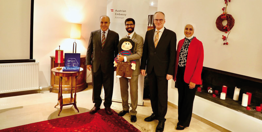 Austrian Ambassador to Jordan Oskar Wüstinger honours the Jordanian Puppets World Organisation for receiving the Intercultural Achievement Award in the technology category, on Monday  (Photo by Osama Aqarbeh)