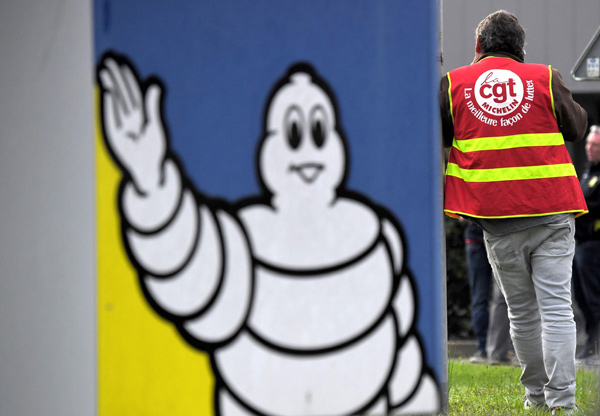 CGT union leader Antony Guilloteau speaks on mobile phone during a protest in front of the Michelin factory after the announcement of the closure of the site on Thursday in La Roche sur Yon (AFP photo)