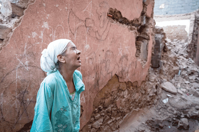 A woman reacts standing in front of her earthquake-damaged house in the old city in Marrakesh on Saturday. A powerful earthquake that shook Morocco late September 8 killed more than 1,000 people, interior ministry figures showed, sending terrified residents fleeing their homes in the middle of the night (AFP photo)