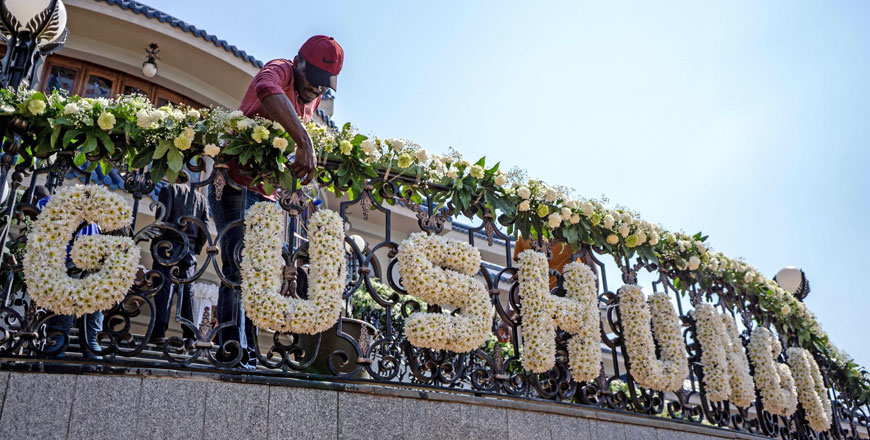A man pours water on flowers forming the word ‘Gushungo’, Zimbabwe's late President Robert Mugabe's clans name, as the body lays in state at the family's Blue Roof residency in Harare, Zimbabwe, on Thursday (AFP photo)
