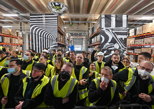 Employees of the Tesla's 'Gigafactory' wearing yellow vests cheer during the start of the production at Tesla's 'Gigafactory' on Tuesday in Gruenheide, southeast of Berlin (AFP photo)