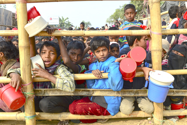 In this photo taken on January 12,  Rohingya Muslim refugees wait for food aid at Thankhali refugee camp in Bangladesh's Ukhia district  (AFP file photo)