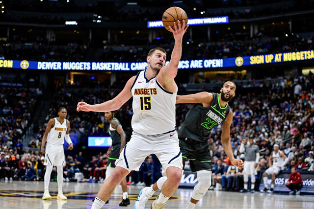 Nikola Jokic #15 of the Denver Nuggets collects a loose ball against Rudy Gobert #27 of the Minnesota Timberwolves in the first half of a game at Ball Arena on Wednesday in Denver, Colorado (AFP photo)