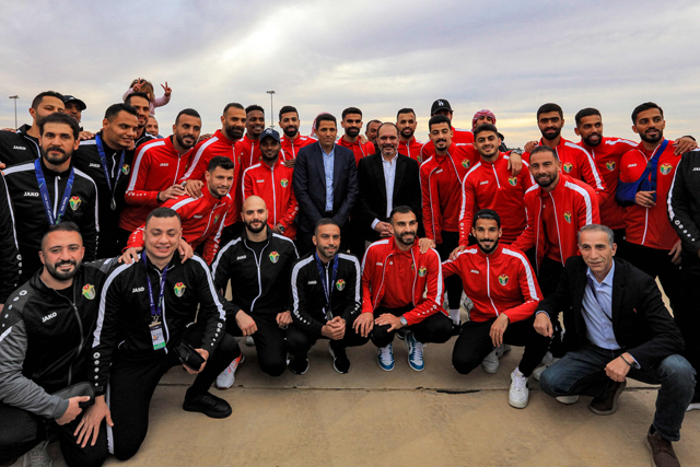 Jordan's Prince Ali Bin Hussein (centre), President of the Jordan Football Association, poses for a group picture with the national team players upon their return from the Qatar 2023 AFC Asian Cup final after reaching second-place in the tournament, at Amman's Queen Alia International Airport on Monday (AFP photo)