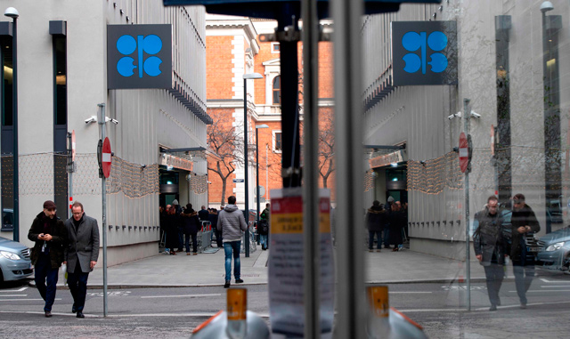 Journalists stand in front of the entrance to the headquarters of the Organisation of the Petroleum Exporting Countries (OPEC) where a meeting of OPEC members and non-OPEC members in Vienna, Austria, was taking place on Friday (AFP photo)