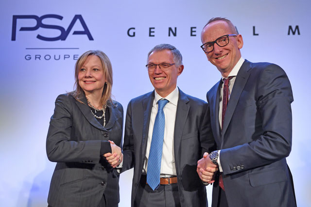 (From left) Chairperson and CEO of General Motors Company Mary T. Barra, chairperson of the managing board of French carmaker Groupe PSA, Carlos Tavares, and Opel CEO Karl Thomas Neumann shake hands during a press conference about the acquisition by PSA of General Motors' European subsidiary, which includes the Opel and Vauxhall brands, in Paris, on Monday  (AFP photo)