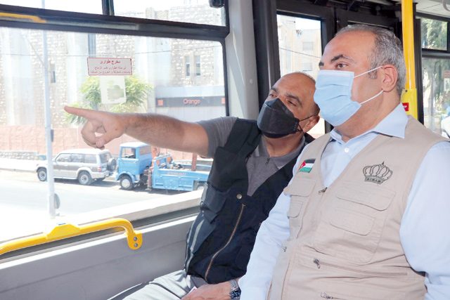 Prime Minister and Minister of Defence Bisher Al Khasawneh takes a ride on BRT bus during the inauguration  of the trial operation on Tuesday (Petra photo)