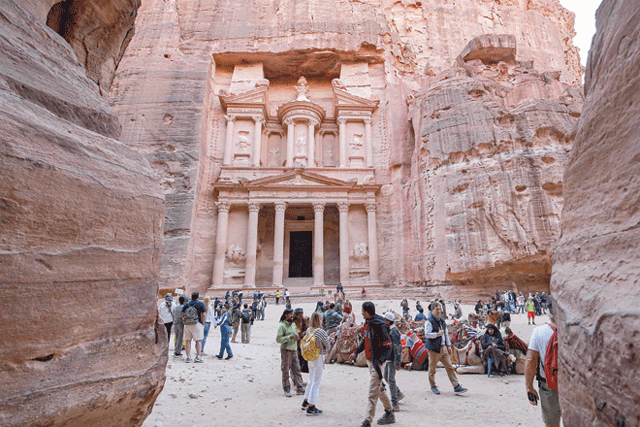Visitors tour near the Treasury at the ruins of the ancient Nabataean city of Petra in southern Jordan on December 12, 2022  (AFP file photo)
