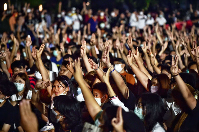 Students flash the three-fingered Hunger Games salute at a pro-democracy rally against the military government at Thammasat University in Bangkok, on Wednesday (AFP photo)