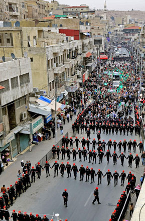 Police stand guard as protesters take part in a demonstration against the US president's decision to recognise Jerusalem as the capital of Israel, on Thursday, in Amman (AFP photo by Khalil Mazraawi)