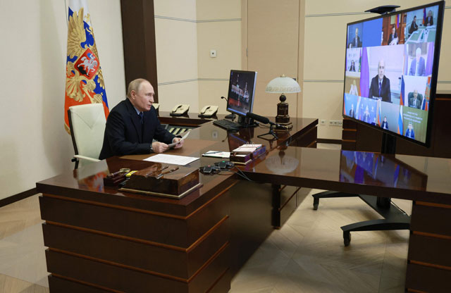 In this pool photograph distributed by the Russian state agency Sputnik, Russia's President Vladimir Putin chairs a meeting to address economic issues via a video conference at the Novo-Ogaryovo state residence, outside Moscow, on Wednesday (AFP file photo)