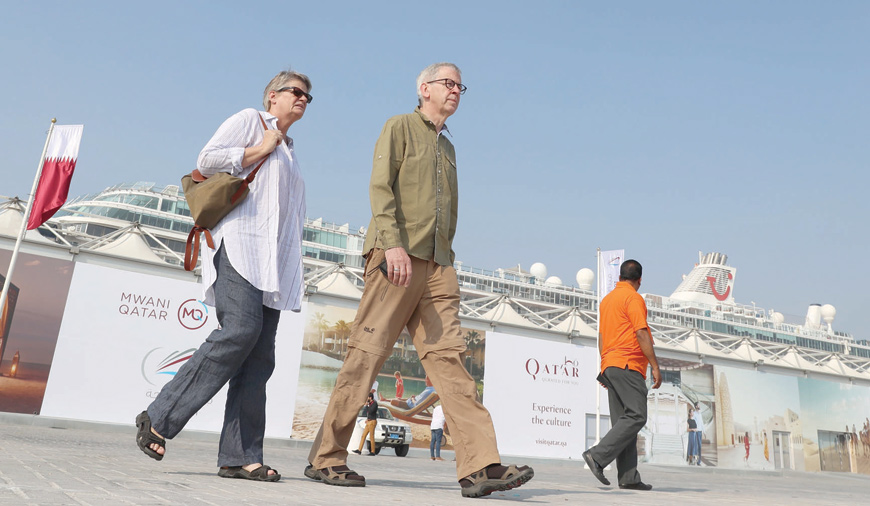 Tourists disembark at Doha Port as a new cruise season kicks off with the launch of a new temporary passenger terminal as Qatar works to increase the number of cruise ships making calls in the Gulf state, in the Qatari capital Doha, on Tuesday  (AFP photo)