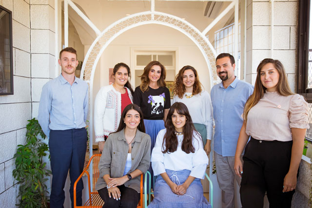 Her Majesty Queen Rania poses for a group photo during a visit to the offices of Amman Design Week in Jabal Amman on Sunday (Photo Courtesy of Royal Court)