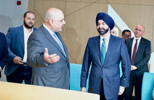 Bank Group President Ajay Banga (right) speaks to Minister of  Digital Economy and Entrepreneurship Ahmad Hanandeh during a field visit on Sunday to Amman Government Service Centre in Muqablain in eastern Amman (Photo by Osama Aqarbeh)