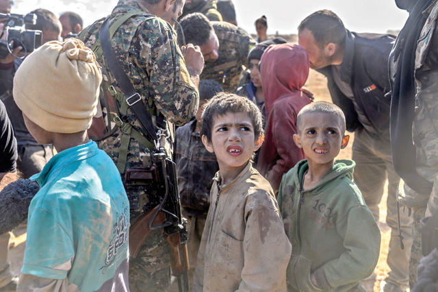 In this photo taken on March 06, 2019, children believed to be from the Yazidi community, who were captured by Daesh group fighters, are pictured after being evacuated from the group’s embattled holdout of Baghouz, at a screening area held by the US-backed Kurdish-led Syrian Democratic Forces, in the eastern Syrian province of Deir Ezzor.  (AFP file photo)