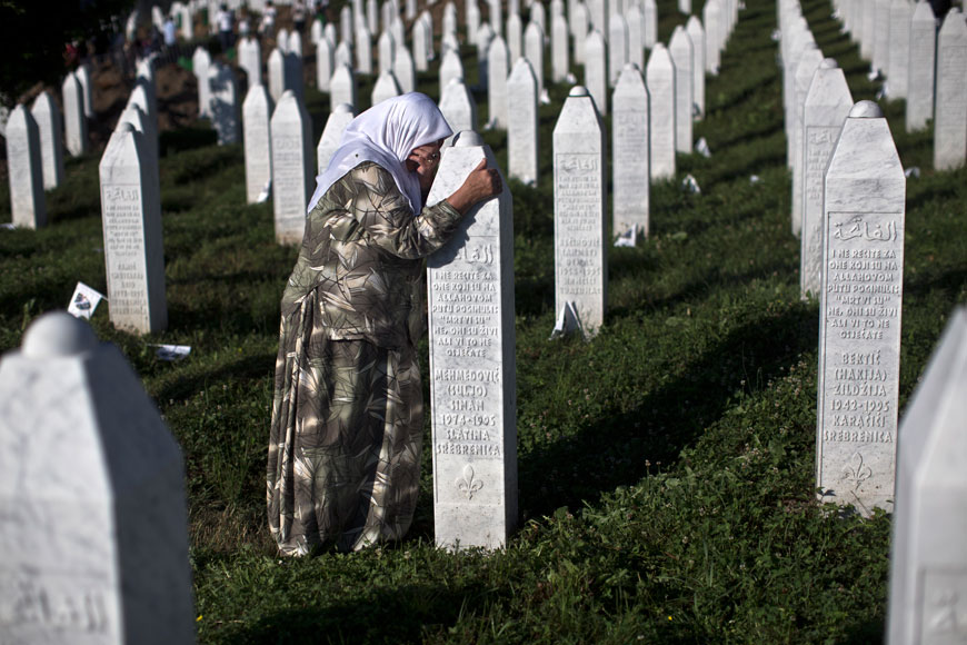 A woman weeps as she visits the grave of a family member at the Potocari memorial complex near Srebrenica, 150 kilometres northeast of Sarajevo, on Saturday (AP photo)