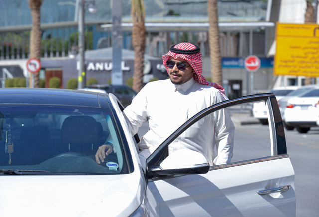 Saudi driver Hussein gets into his car as he starts his day working for Uber, in the capital Riyadh, on Thursday  (AFP photo)