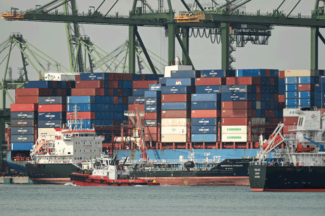 A pilot boat sails past container vessels at Pasir Panjang port terminal in Singapore on Tuesday (AFP photo)